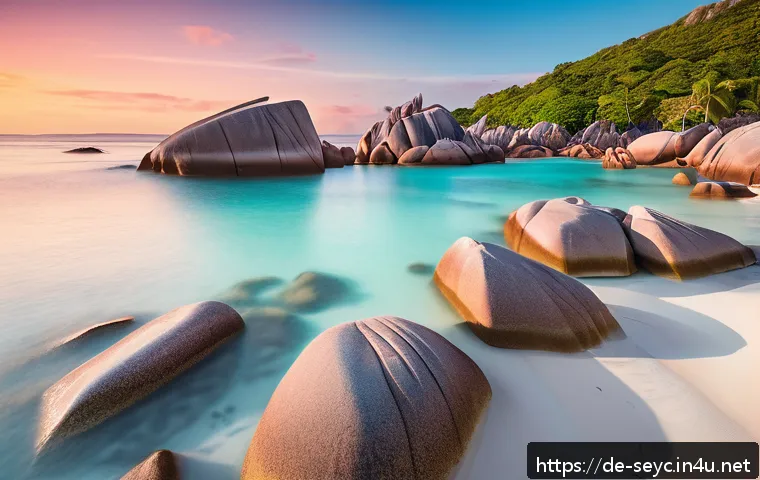 세이셸 유명 사진 작가 추천 - A serene early morning scene at Anse Source d&rsquo;Argent beach on La Digue Island, featuring massive pin...